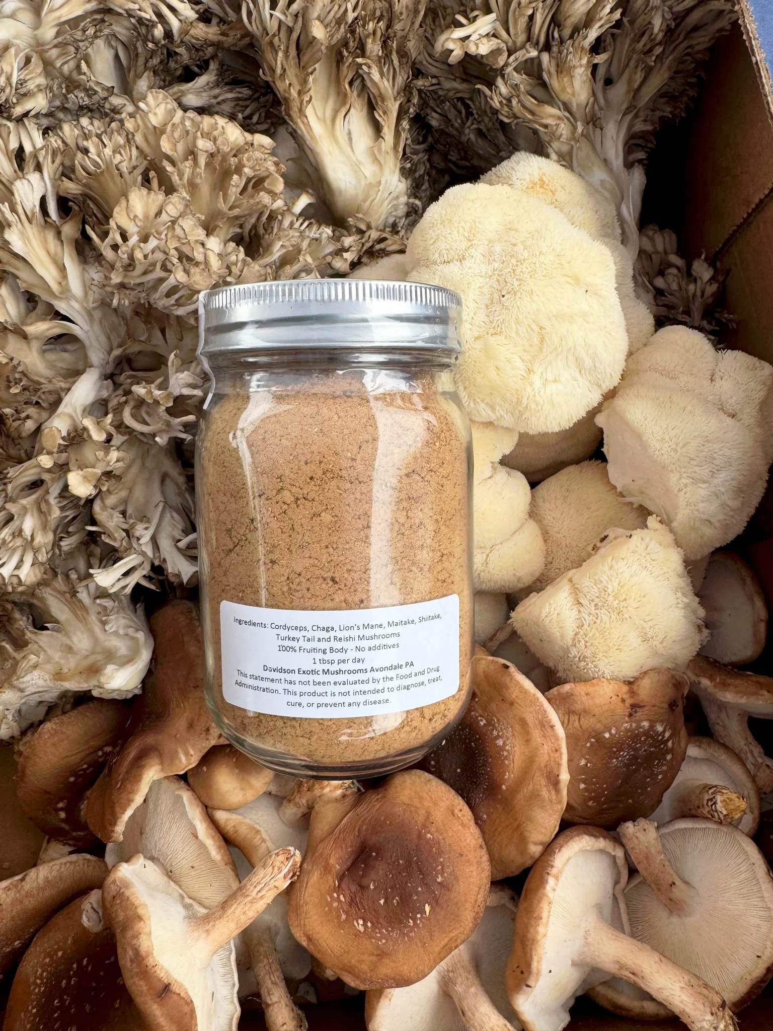 The back label of "Johnny Blend Plus", listing its seven mushrooms: Cordyceps, Chaga, Lion's Mane, Maitake, Shiitake, Turkey Tail and Reishi, and a serving of one tablespoon a day.